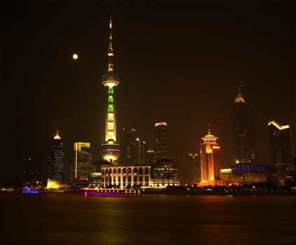 Shanghai Pudong China Skyline at Night TV Tower with Boats, Reflections and Moon

Trademarks removed.