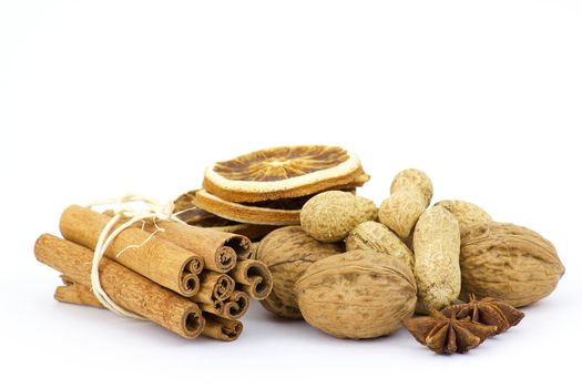 cinnamon sticks, nuts, anise stars and sliced of dried orange