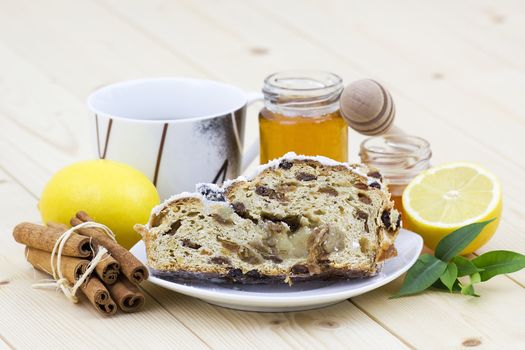 christmas stollen, honey, lemon and cinnamon sticks