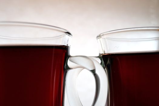 Two glass cups over white background