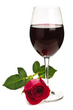 Romantic glass of red wine with long stemmed rose isolated on white background