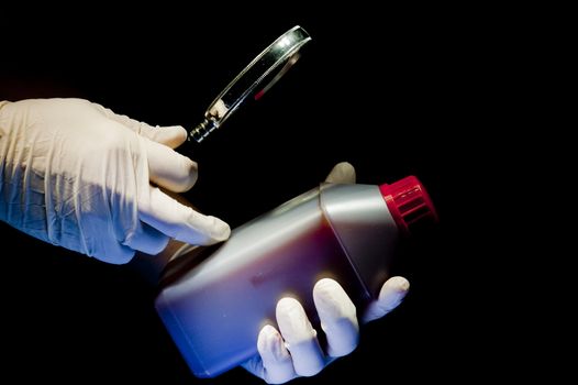 Two hands covered in white gloves and container