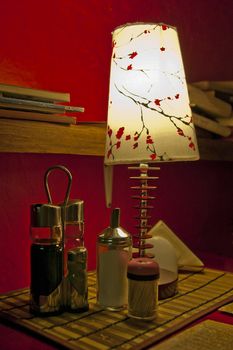 Lamp standing next to sugar, tea, coffee container