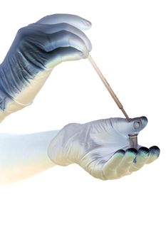 Shaded hands in gloves hold pipette and tube