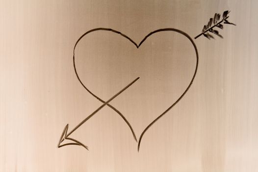 Someone draw shaded love symbol on school desk