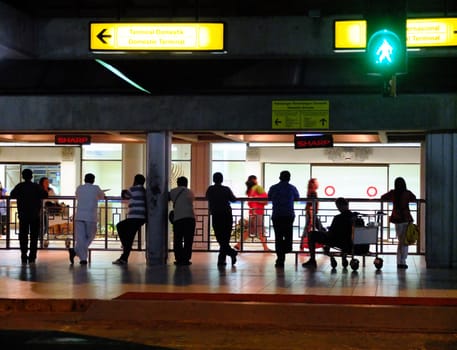 People waiting for passengers at an airport, Bali, Indonesia.