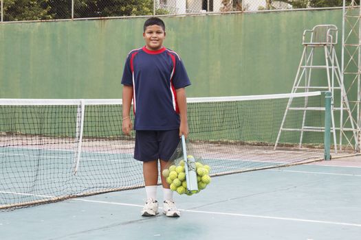 Thai boy with tennis balls