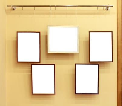 5 frames with isolated canvas on the exhibition ledge