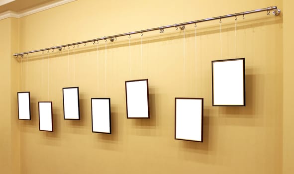 7 frames with isolated canvas on the exhibition ledge