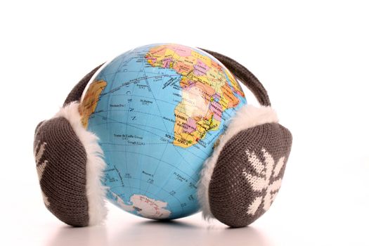 Earmuffs on a globe to express winter
