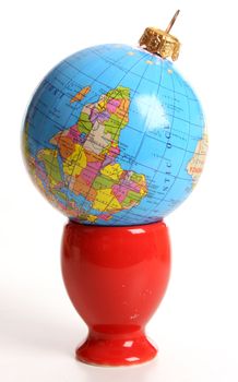 Globeas a Christmas ball  in an egg cup