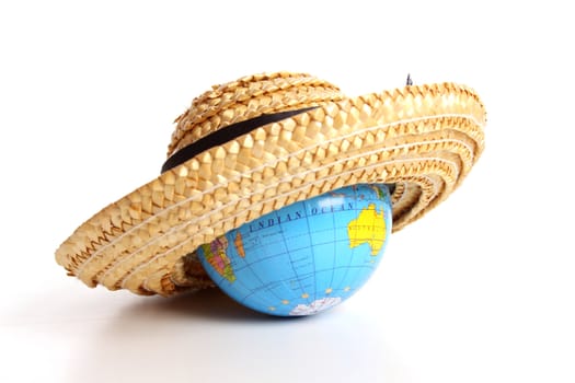 Straw hat covering a globe for the holidays