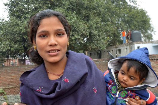 New Delhi,India-February 4, 2013:a woman and her son lives in the slums of New Delhi on February 4,2013. 50% of the population of New Delhi is thought to live in slums, in New Delhi