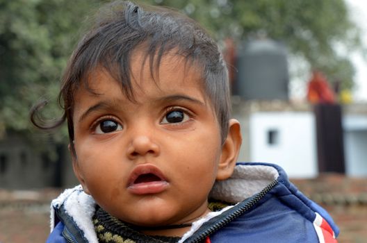 New Delhi,India-February 4, 2013:An unidentified child lives in the slums of New Delhi. 50% of the population of New Delhi is thought to live in slums,on February 4,2013 in New Delhi