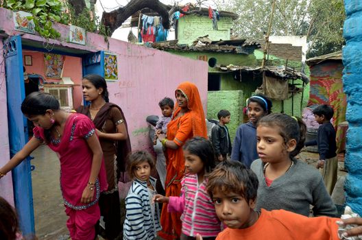 New Delhi,India-February 4, 2013:a group of mothers and children living in the slums of New Delhi, on February 4,2013. In India dramatically increases the number of poor.