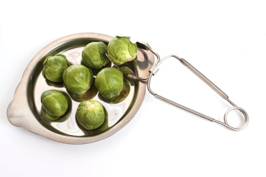 Brussels sprouts in a studio setting over white