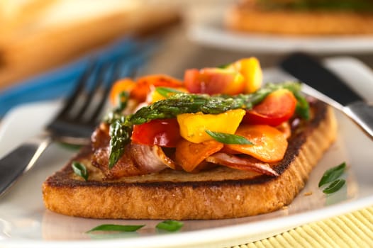 Baked asparagus, mango, tomato, carrot and bacon sandwich on wholewheat toast bread (Selective Focus, Focus on the asparagus tips in the front)