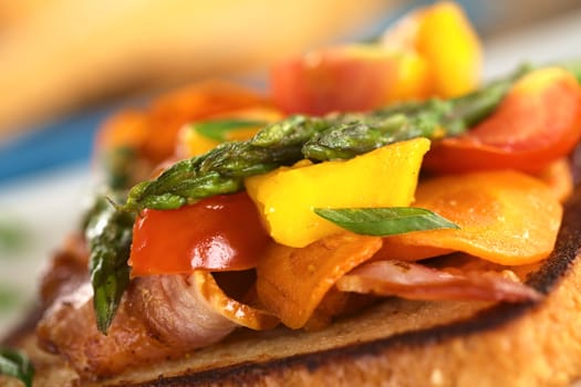 Baked asparagus, mango, tomato, carrot and bacon sandwich on wholewheat toast bread (Selective Focus, Focus on the two asparagus tips on the top)