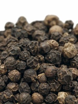 close up of black peppercorns