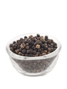 close up of black peppercorns blur