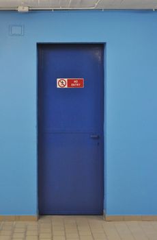No entry sign on a blue firewall door