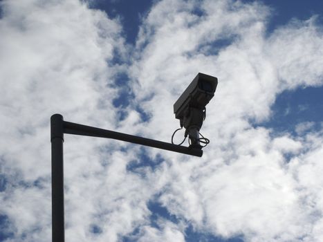 CCTV camera against a vivid sky