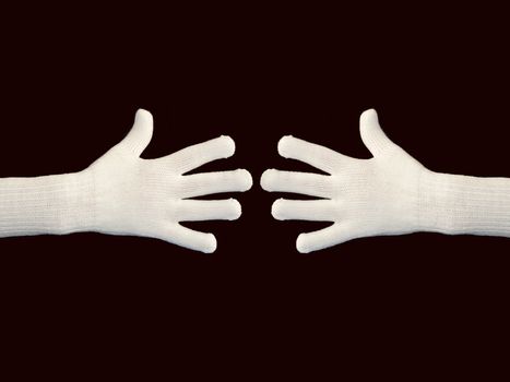 Hands in white gloves on black background