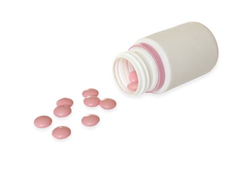 Pink pills and white bottle isolated