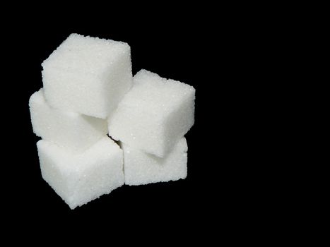group of sugar cubes on black background