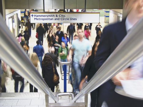 Commuters returning from work, ascending stairs in London Underground