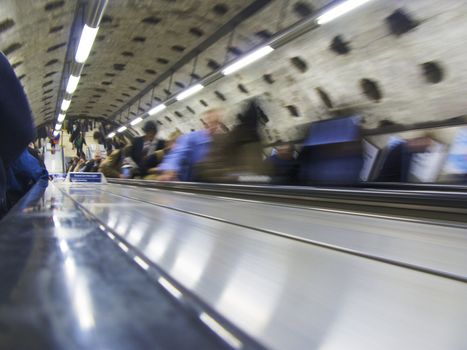 A 1/4 second exposure of commuters on an escalator in London underground 