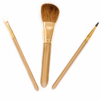 Three brushes for a make-up on a white background