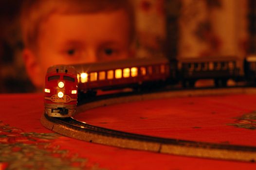 Norwegian christmas.
Boy have fun with an electrical model train. 
It`s only at christmas this train is up.