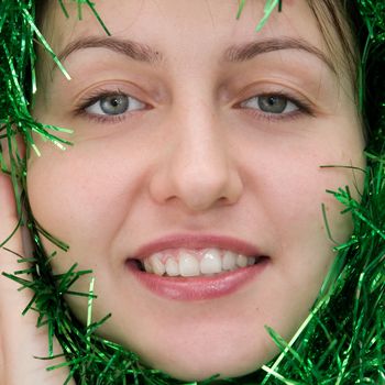 Christmas. New Year.  Beautiful smiling woman with tinsel.