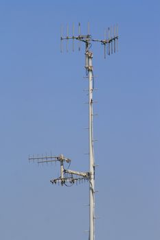 Close up of an antena over blue sky.
