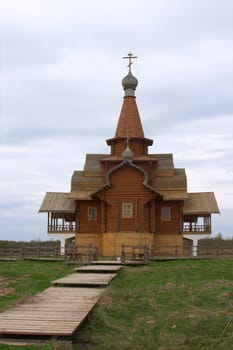 Small orthodox church from wood over blue sky