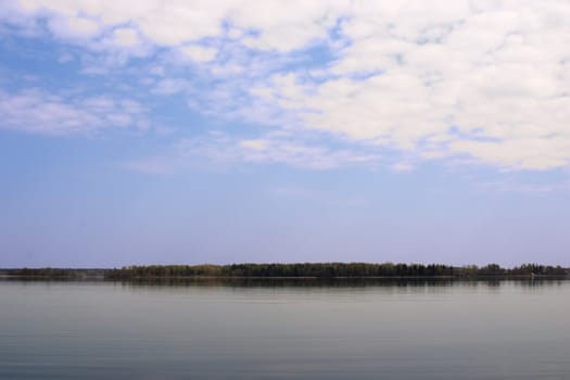 Lake Seliger with green forest over blue sky