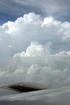 Wing of the plane on a background of clouds