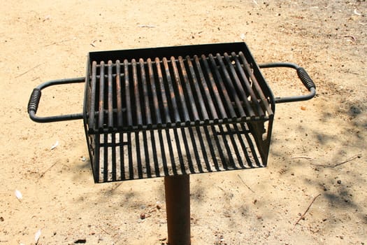 Close up of a grill in a park.
