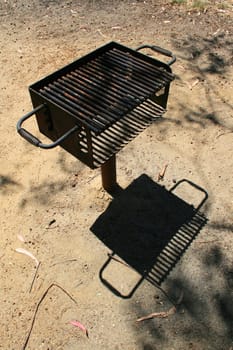 Close up of a grill in a park.
