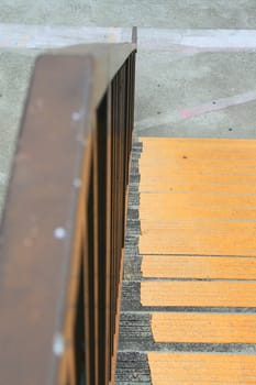 Close up of a handrail and the stairs.
