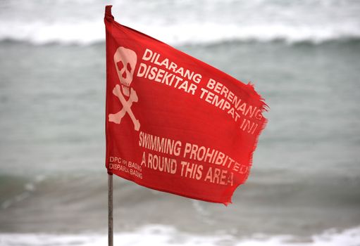 Swimming prohibited around this area flag in Kuta beach Bali