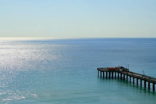 Big long pier on a sunny day.
