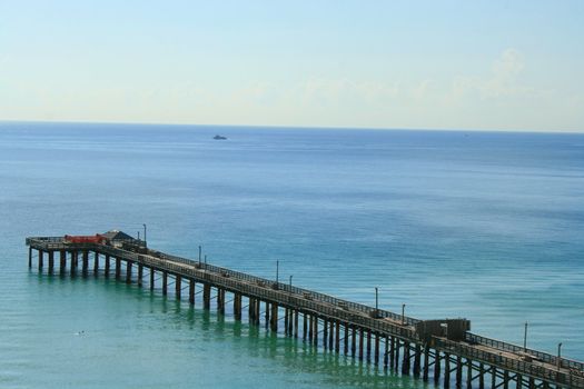 Big long pier on a sunny day.
