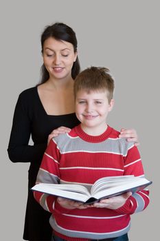 Family with book on a grey background