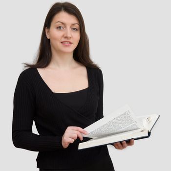 beautiful woman with big Bible on a grey background