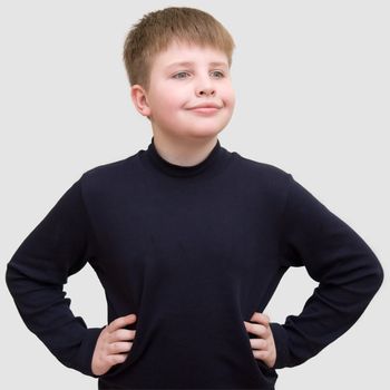 smiling little boy on a grey background