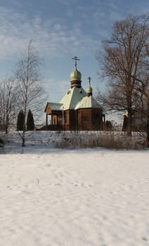 Chapel on the shore of a frozen lake in winter