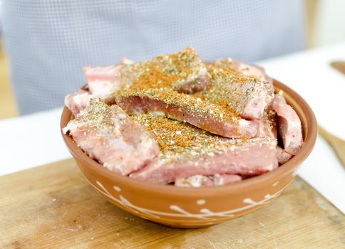 raw pork ribs with spices on a plate