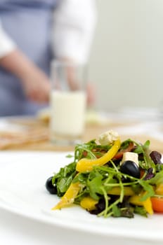 fresh Greek salad on white plate, cook on background